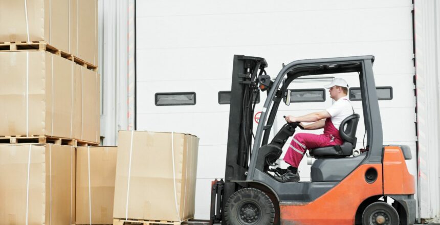 12874549 - worker driver at warehouse forklift loader works